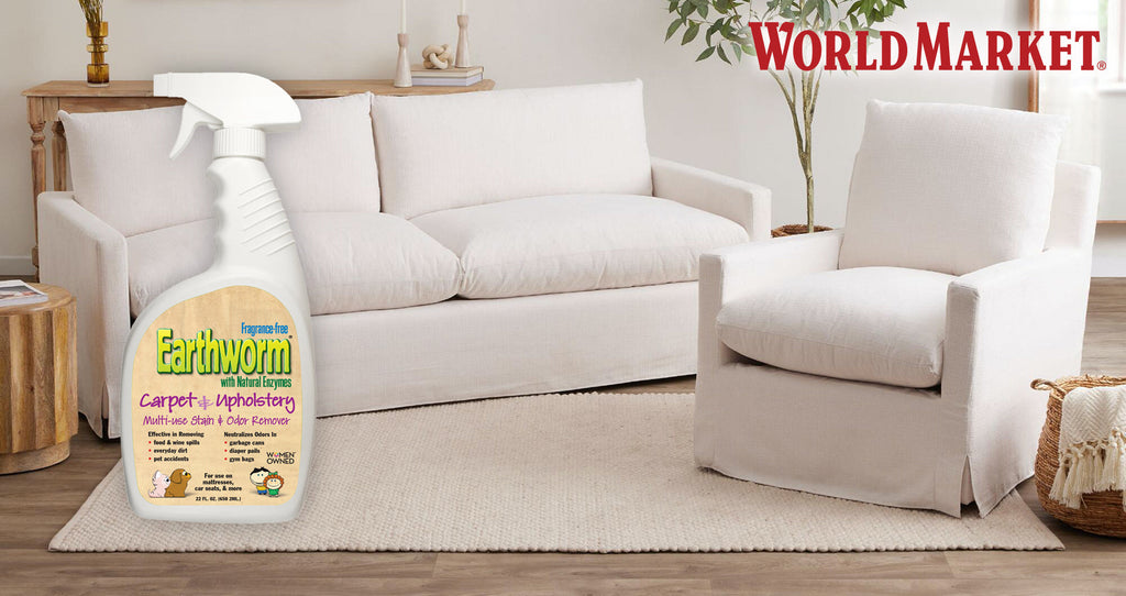 Earthworm Carpet and Upholstery Cleaner in front of a white sofa and armchair, with the World Market logo