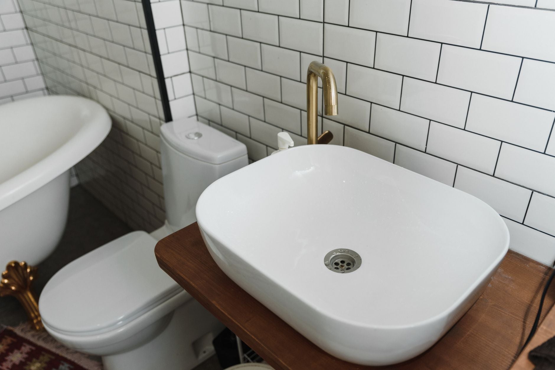 Stylish bathroom interior featuring a ceramic sink, bathtub, and modern fixtures